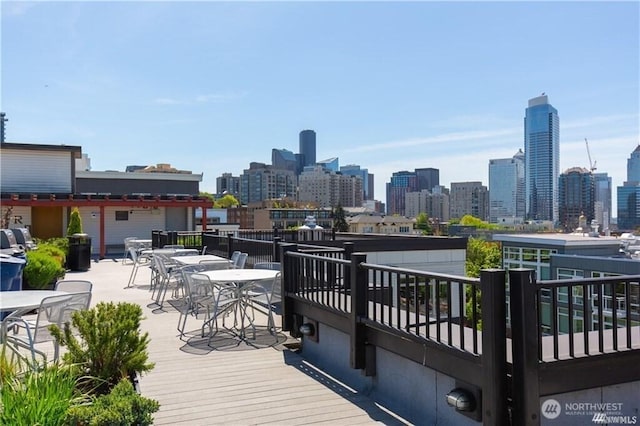1610 Belmont Ave Unit 606, Seattle, WA 98122 - wooden terrace with outdoor dining area and a skyline view