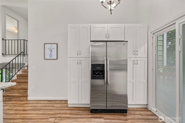4209 S 297th Pl, Auburn, WA 98001 - kitchen with stainless steel refrigerator with ice dispenser, light wood finished floors, and white cabinetry