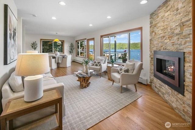 13190 Riviera Pl NE, Seattle, WA 98125 - living area featuring a baseboard heating unit, recessed lighting, light wood-type flooring, and a fireplace