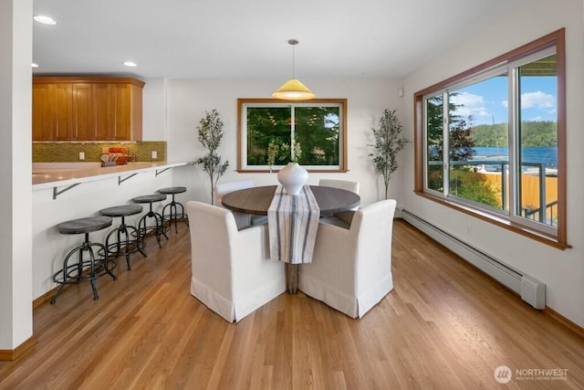 13190 Riviera Pl NE, Seattle, WA 98125 - dining room with a baseboard radiator, light wood-style flooring, and recessed lighting