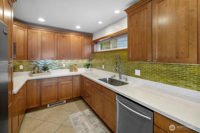 13190 Riviera Pl NE, Seattle, WA 98125 - kitchen with stainless steel dishwasher, tasteful backsplash, brown cabinetry, light countertops, and recessed lighting