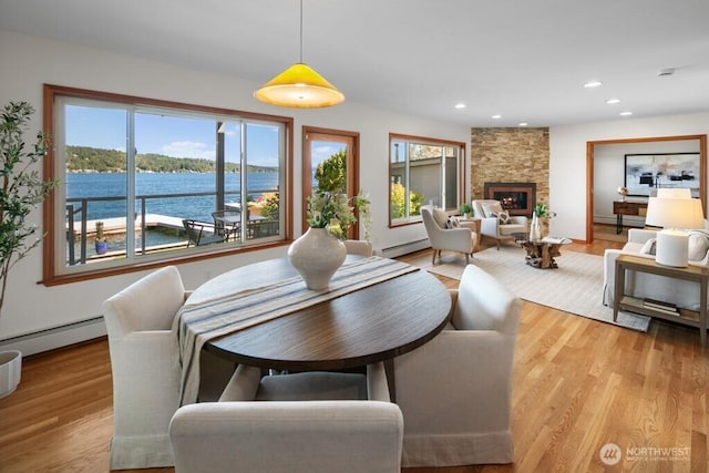 13190 Riviera Pl NE, Seattle, WA 98125 - dining room featuring a baseboard heating unit, light wood-type flooring, recessed lighting, and a fireplace