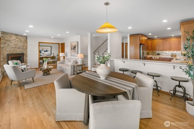 13190 Riviera Pl NE, Seattle, WA 98125 - living room with stairs, recessed lighting, light wood-type flooring, and a fireplace