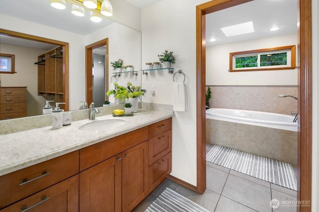 13190 Riviera Pl NE, Seattle, WA 98125 - bathroom featuring vanity, tile patterned floors, a bath, and a skylight