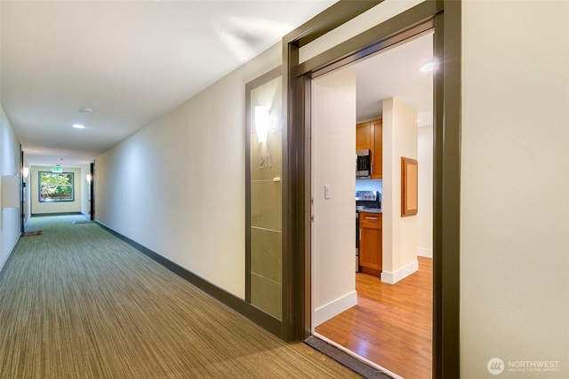 21307 48th Ave W Unit C211, Mountlake Terrace, WA 98043 - hallway with baseboards and light carpet