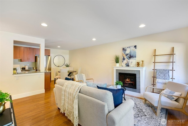 21307 48th Ave W Unit C211, Mountlake Terrace, WA 98043 - living room with light wood-type flooring, a tile fireplace, and recessed lighting