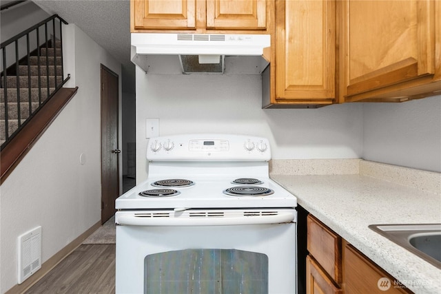23 S 338th Pl, Federal Way, WA 98003 - kitchen featuring white electric range oven, under cabinet range hood, and wood finished floors