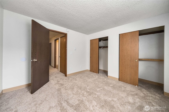 23 S 338th Pl, Federal Way, WA 98003 - unfurnished bedroom featuring carpet, a textured ceiling, and two closets