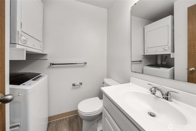23 S 338th Pl, Federal Way, WA 98003 - bathroom with stacked washer / drying machine, wood finished floors, and vanity