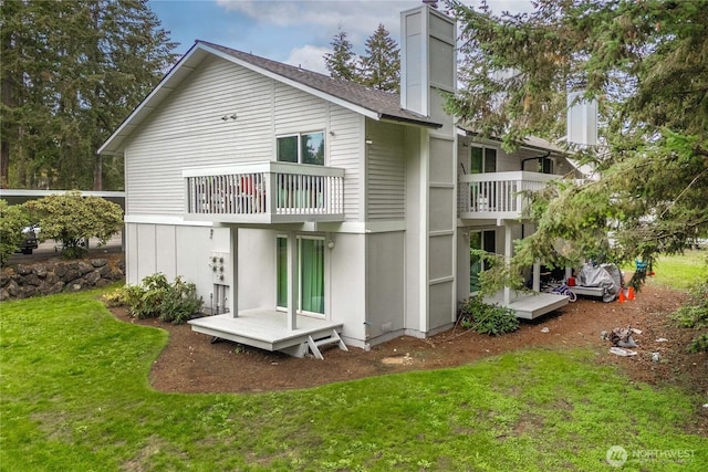 23 S 338th Pl, Federal Way, WA 98003 - back of property featuring a balcony, a chimney, a yard, and roof with shingles
