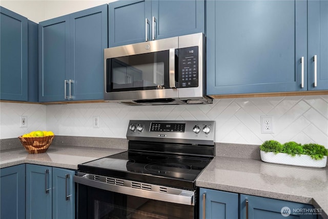 2101 62nd St SE, Auburn, WA 98092 - kitchen with stainless steel appliances, blue cabinetry, and tasteful backsplash