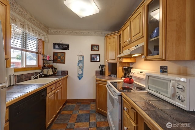 210 26th Street Nw 203&04, Long Beach, WA 98631 - kitchen with white appliances, under cabinet range hood, tile counters, glass insert cabinets, and dark stone finish flooring