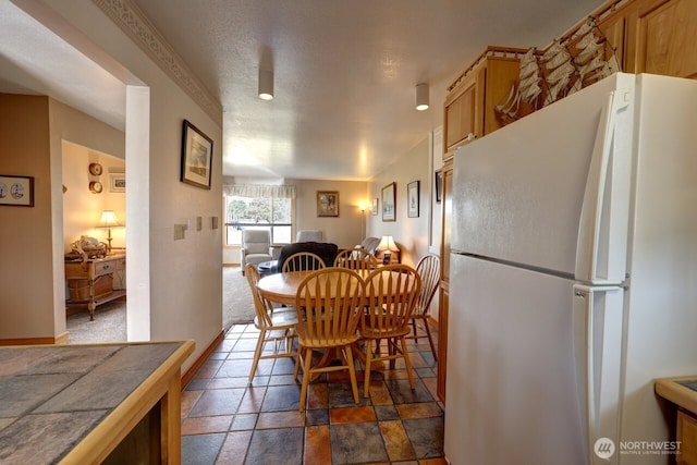 210 26th Street Nw 203&04, Long Beach, WA 98631 - dining area featuring baseboards and dark stone finish floors