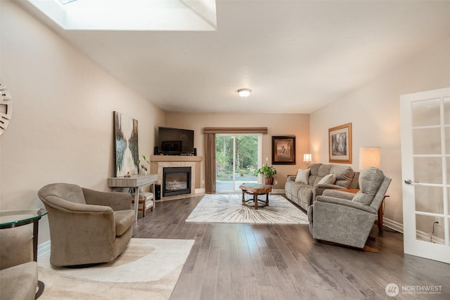 1122 36th Ave NE, Olympia, WA 98506 - living room with hardwood / wood-style floors, a glass covered fireplace, and a skylight