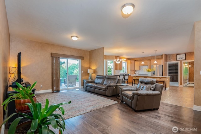 1122 36th Ave NE, Olympia, WA 98506 - living room with light wood-type flooring, beverage cooler, and a chandelier