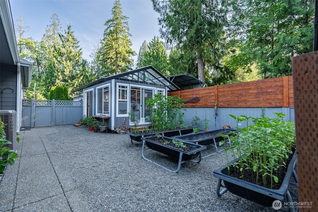 1122 36th Ave NE, Olympia, WA 98506 - fenced backyard featuring a vegetable garden and an outdoor structure