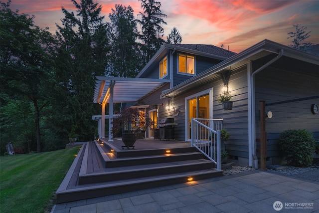 1122 36th Ave NE, Olympia, WA 98506 - back of property at dusk featuring a yard and a deck