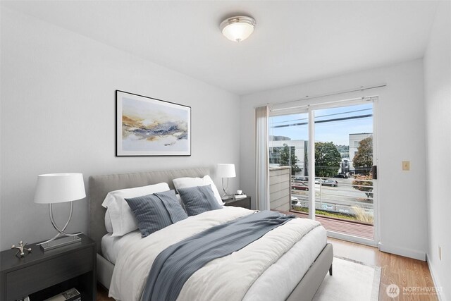 2727 E Franklin Ave E Unit 102, Seattle, WA 98102 - bedroom with wood finished floors and access to outside