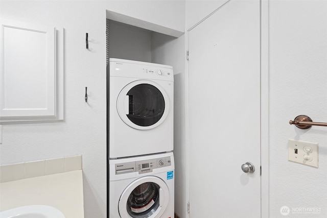2727 E Franklin Ave E Unit 102, Seattle, WA 98102 - laundry area featuring stacked washer / dryer