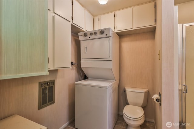 24302 Saddle St, Leavenworth, WA 98826 - laundry area with stacked washer / drying machine, tile patterned flooring, and heating unit