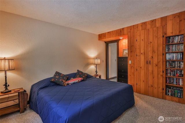24302 Saddle St, Leavenworth, WA 98826 - carpeted bedroom featuring wood walls and a textured ceiling