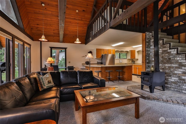 24302 Saddle St, Leavenworth, WA 98826 - living area with light colored carpet, high vaulted ceiling, a wood stove, a wooden ceiling with exposed beams, and stairs