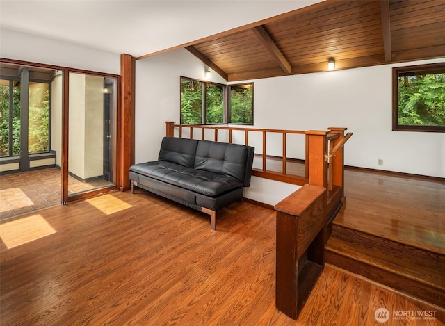 living room featuring plenty of natural light, wooden ceiling, and wood finished floors