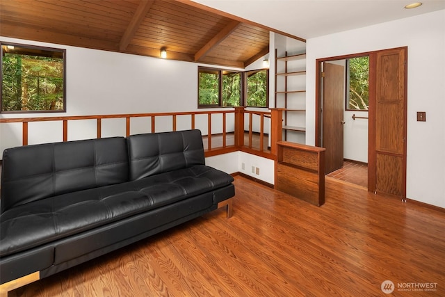 living area with wood finished floors and wooden ceiling