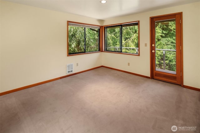 carpeted empty room with baseboards and recessed lighting