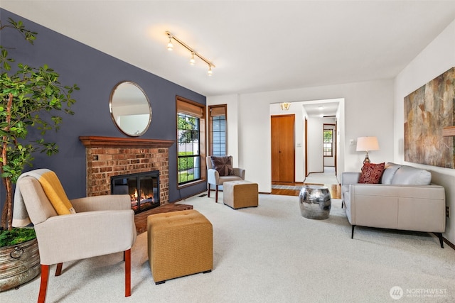 5040 Mill Pond Loop SE, Auburn, WA 98092 - carpeted living room featuring plenty of natural light, a brick fireplace, and track lighting