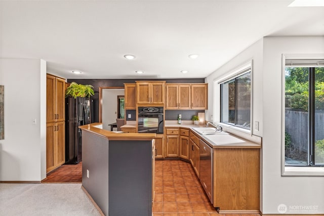 5040 Mill Pond Loop SE, Auburn, WA 98092 - kitchen with black appliances, light countertops, a kitchen island, recessed lighting, and brown cabinets
