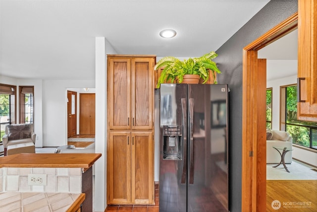 5040 Mill Pond Loop SE, Auburn, WA 98092 - kitchen featuring refrigerator with ice dispenser, brown cabinets, and wood finished floors