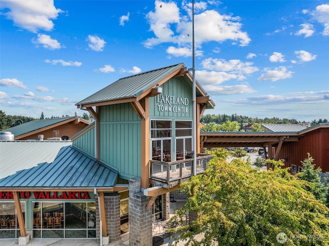 5040 Mill Pond Loop SE, Auburn, WA 98092 - view of side of home with board and batten siding, a metal roof, and a standing seam roof