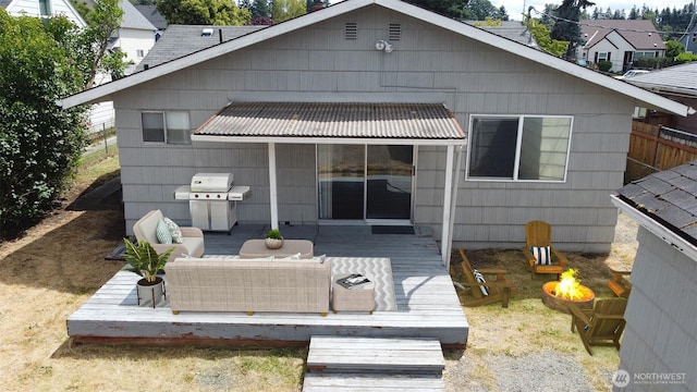 7014 S Fife St, Tacoma, WA 98409 - back of property with an outdoor fire pit and a wooden deck