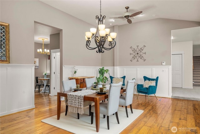4119 72nd St E, Tacoma, WA 98443 - dining area featuring a chandelier, a ceiling fan, wainscoting, light wood-style floors, and a decorative wall