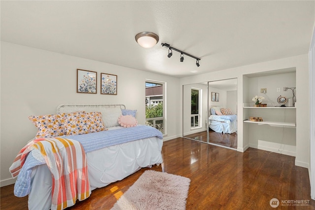 4119 72nd St E, Tacoma, WA 98443 - bedroom with wood finished floors, rail lighting, and a closet