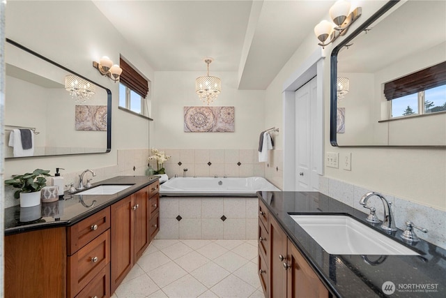 4119 72nd St E, Tacoma, WA 98443 - bathroom featuring a chandelier, two vanities, tile patterned flooring, and a garden tub