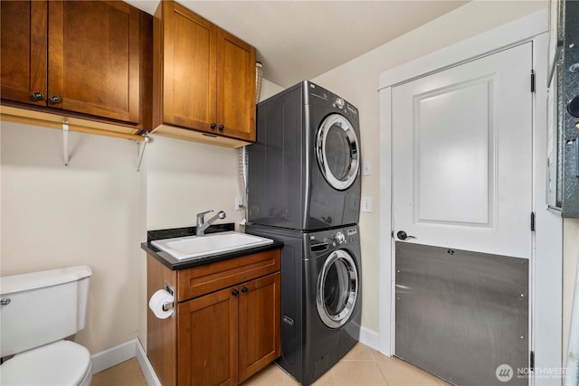 4119 72nd St E, Tacoma, WA 98443 - laundry area with stacked washer and clothes dryer and light tile patterned floors