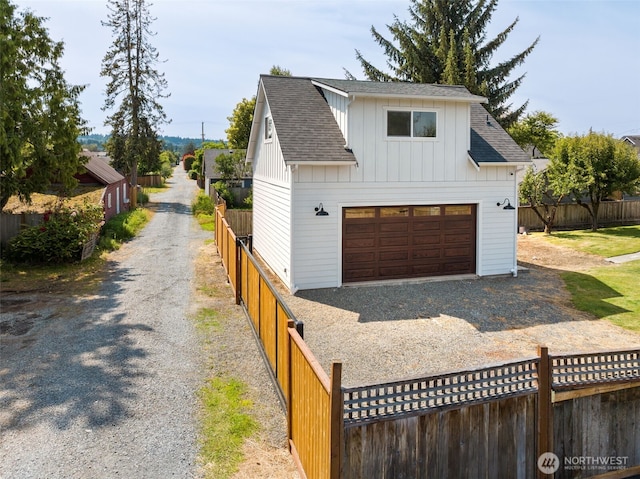 724 6th Ave SW, Puyallup, WA 98371 - view of front of property featuring roof with shingles, board and batten siding, a garage, and driveway