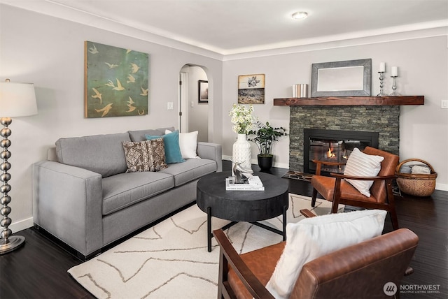1321 Kossuth Ave, Everett, WA 98203 - living area with wood finished floors, arched walkways, and a stone fireplace