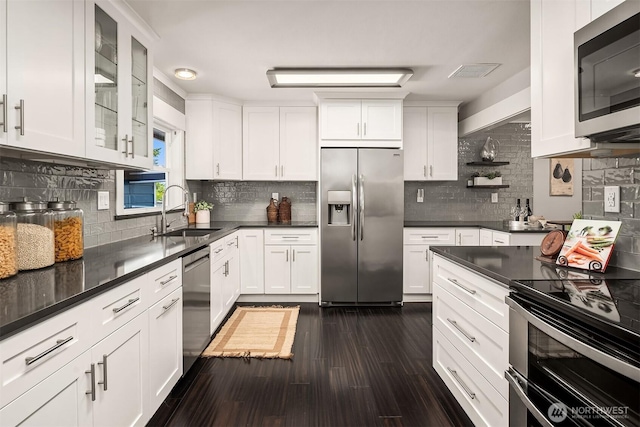 1321 Kossuth Ave, Everett, WA 98203 - kitchen featuring appliances with stainless steel finishes, dark wood-style floors, and white cabinets