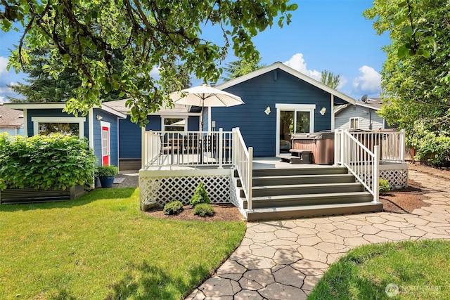 1321 Kossuth Ave, Everett, WA 98203 - back of property with a hot tub, a lawn, and a wooden deck