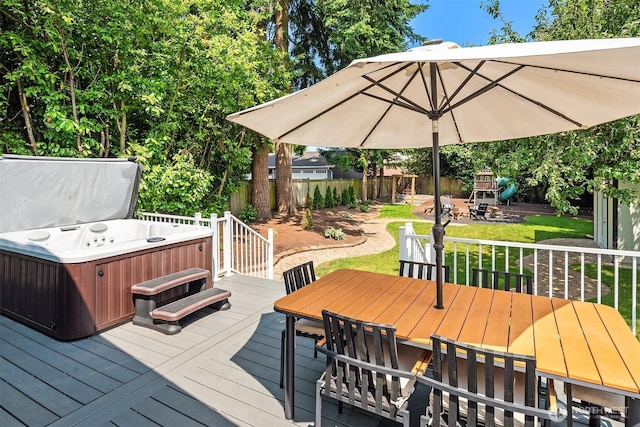 1321 Kossuth Ave, Everett, WA 98203 - wooden deck featuring outdoor dining space, a hot tub, a fenced backyard, and a playground