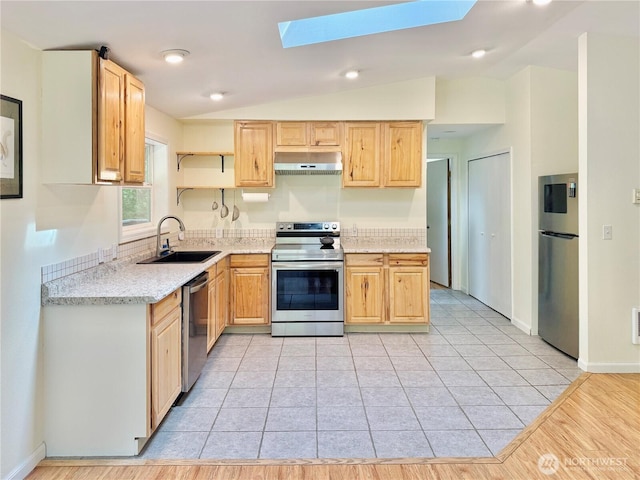 11422 Leschi Cir, Anderson Island, WA 98303 - kitchen featuring appliances with stainless steel finishes, under cabinet range hood, a skylight, light brown cabinets, and lofted ceiling