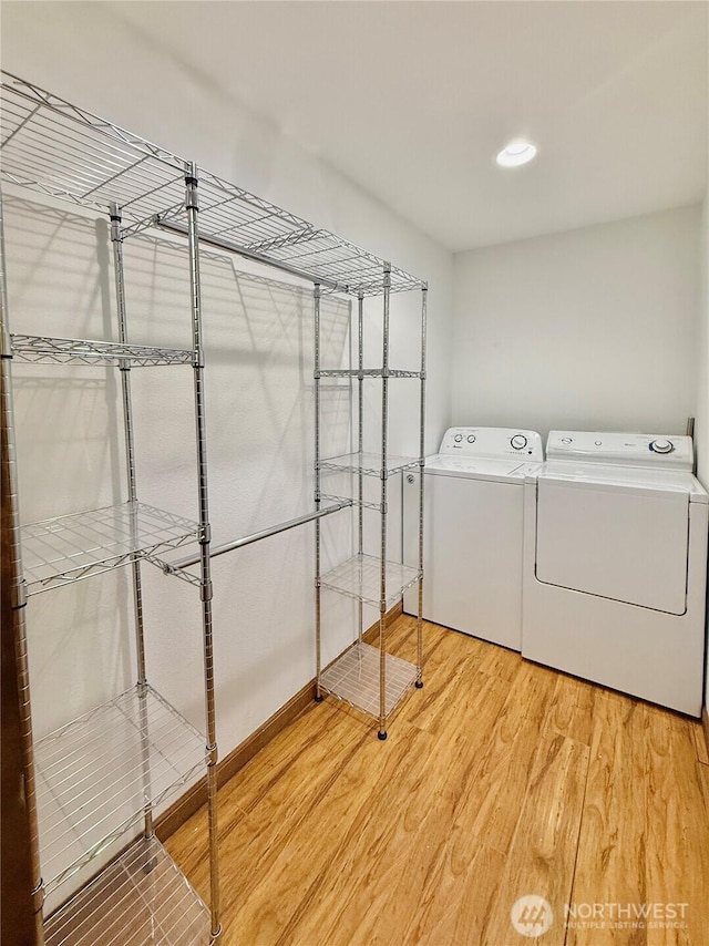 11422 Leschi Cir, Anderson Island, WA 98303 - washroom with washing machine and dryer and light wood finished floors