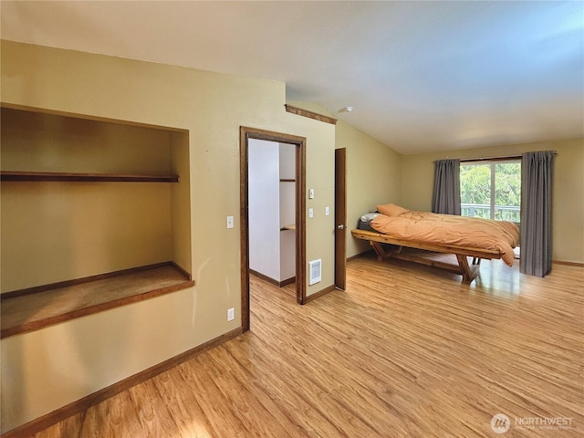 11422 Leschi Cir, Anderson Island, WA 98303 - bedroom with vaulted ceiling and light wood-style flooring