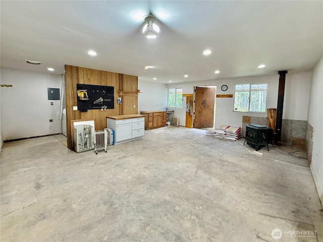 11422 Leschi Cir, Anderson Island, WA 98303 - kitchen featuring concrete floors, a wood stove, healthy amount of natural light, and recessed lighting
