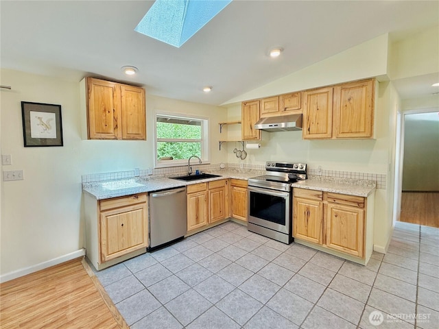11422 Leschi Cir, Anderson Island, WA 98303 - kitchen featuring stainless steel appliances, under cabinet range hood, light brown cabinetry, a skylight, and lofted ceiling