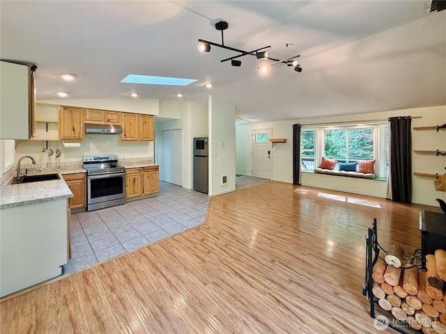 11422 Leschi Cir, Anderson Island, WA 98303 - kitchen with stainless steel range with electric stovetop, under cabinet range hood, lofted ceiling, open floor plan, and a skylight