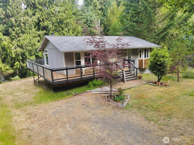 11422 Leschi Cir, Anderson Island, WA 98303 - single story home featuring roof with shingles, covered porch, a front yard, and a forest view